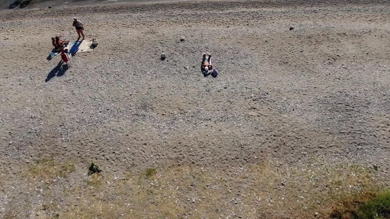 Aerial bird's eye view flight from beach to the sea Turkey