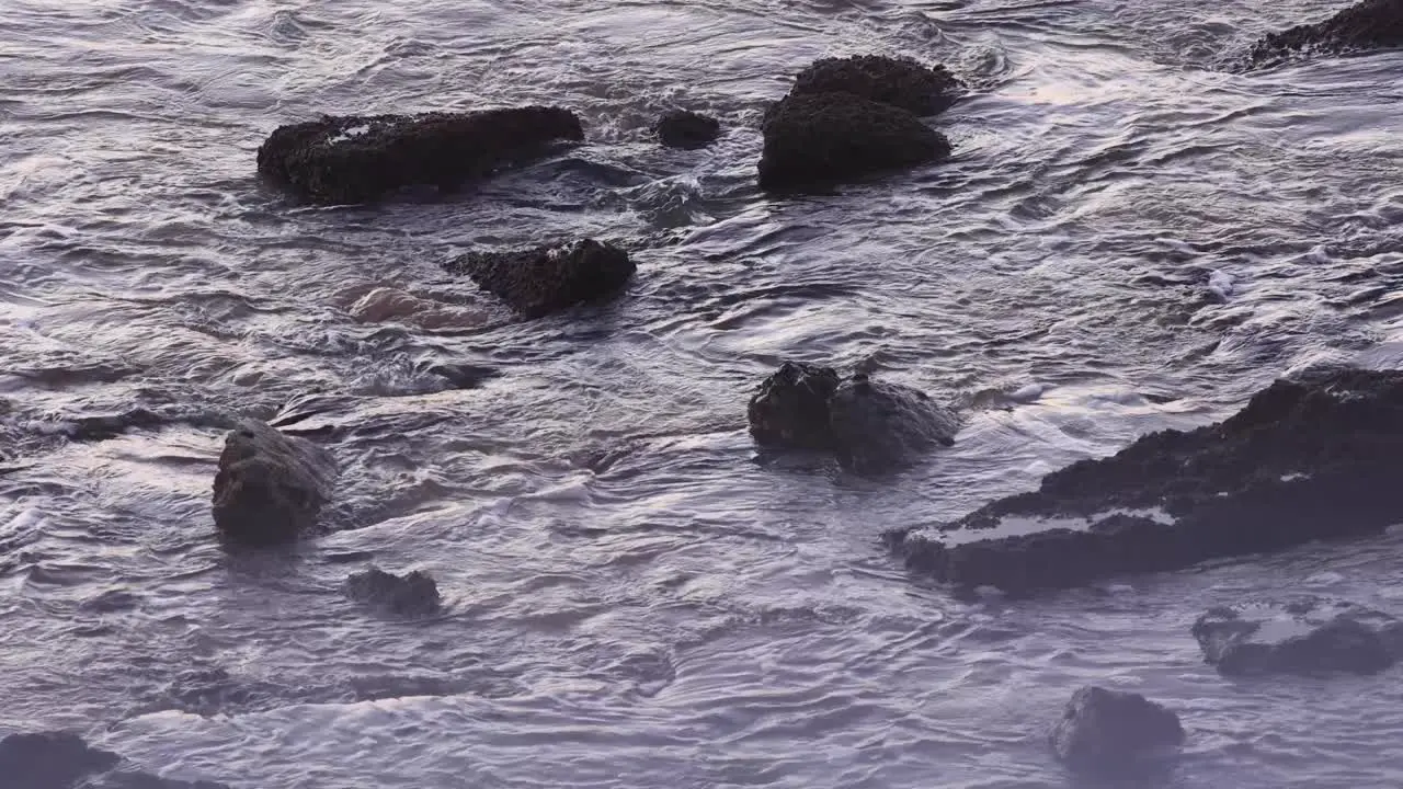 Ocean Waves Breaking On Beach Rocks On Sunny Day