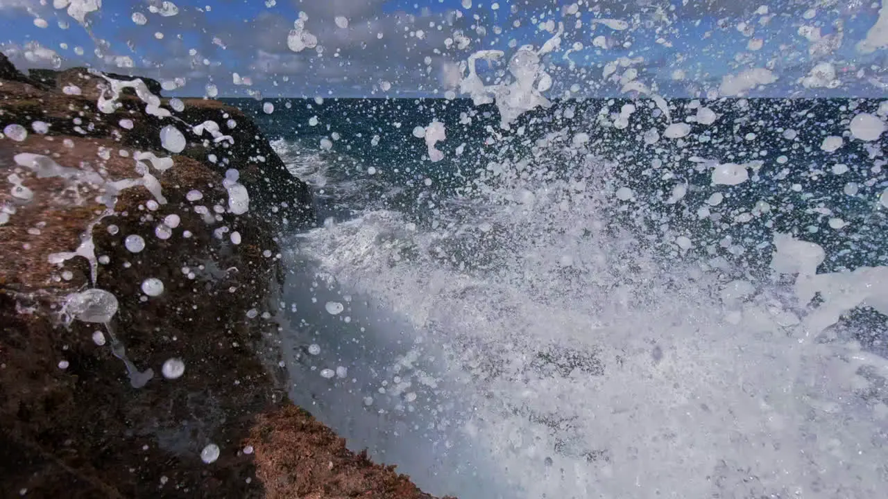 Waves crashing against coastal rocky shoreline powerful wave erosion