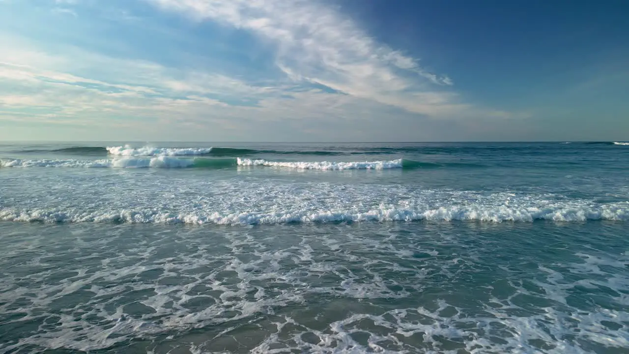 Waves Approaching On The Shore With Blue Sky At Background In Caion Galicia Spain