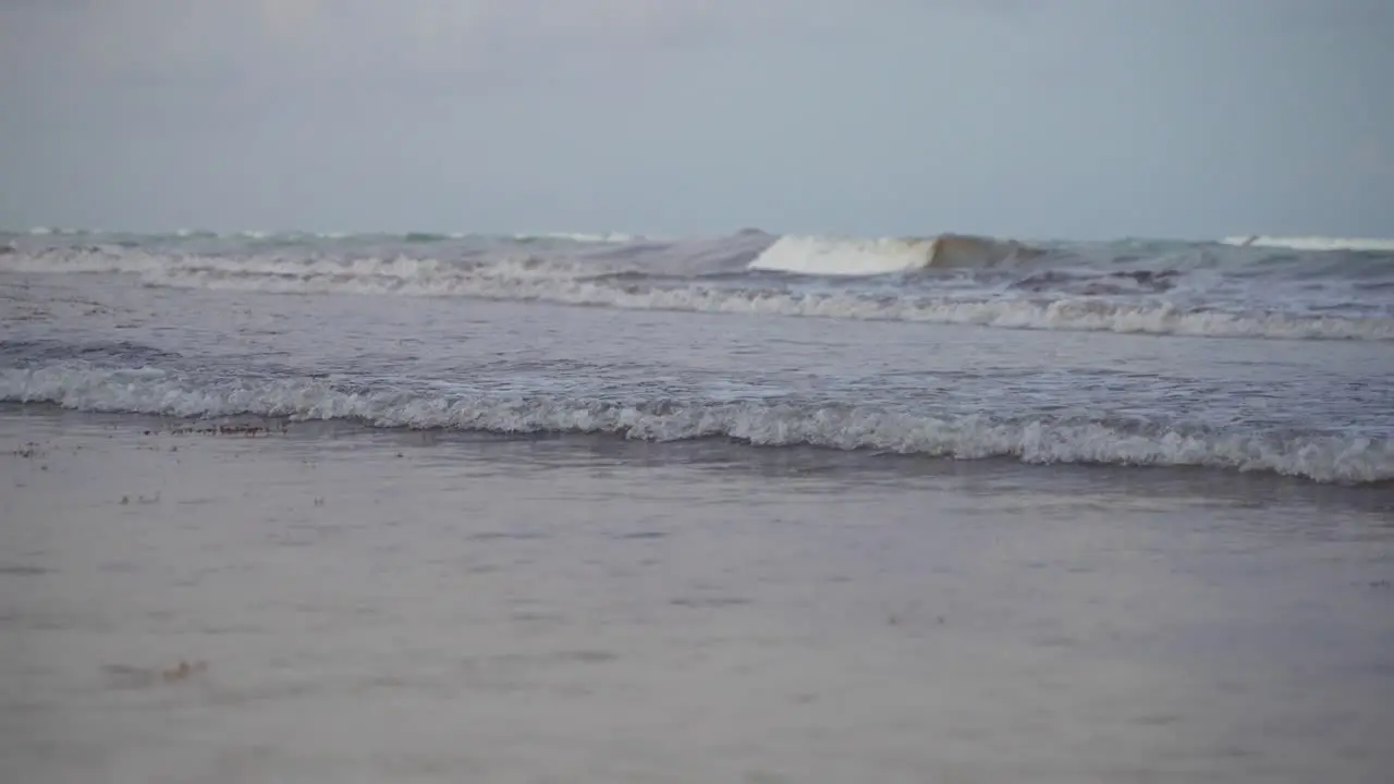 Super Slow Motion Shot Of Small Waves Rolling And Breaking On Beach Shore During Grey Evening Twilight After Sunset