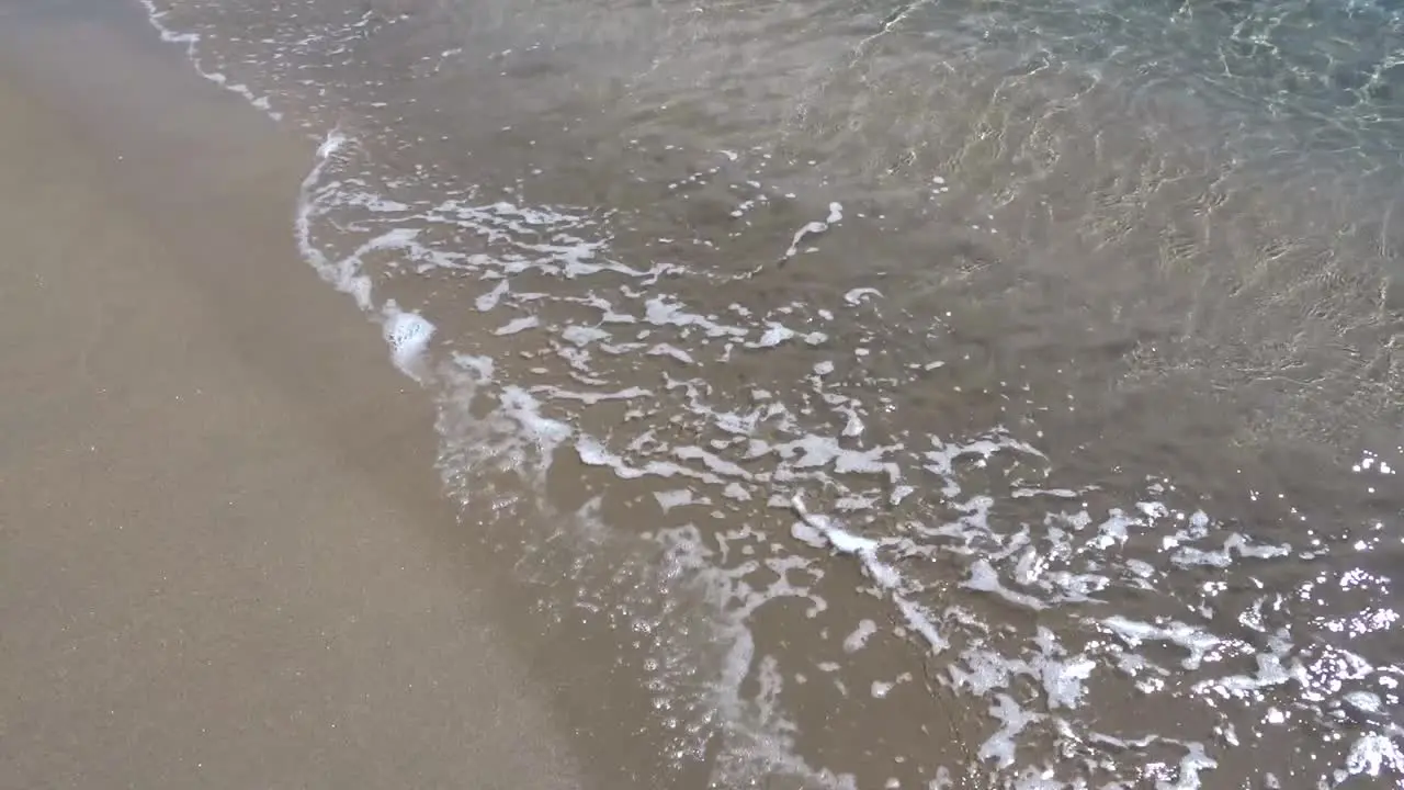 Small waves over the sand of a beach in the Spanish Mediterranean coast