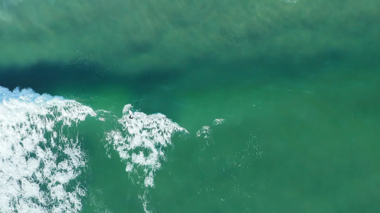 Surfer Over Tidal Waves Of Blouberg Sea In Cape Town South Africa