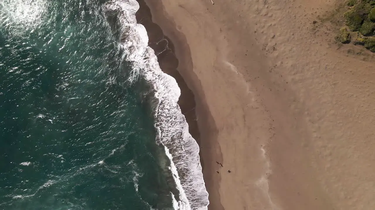 Top down aerial view of waves in the beach