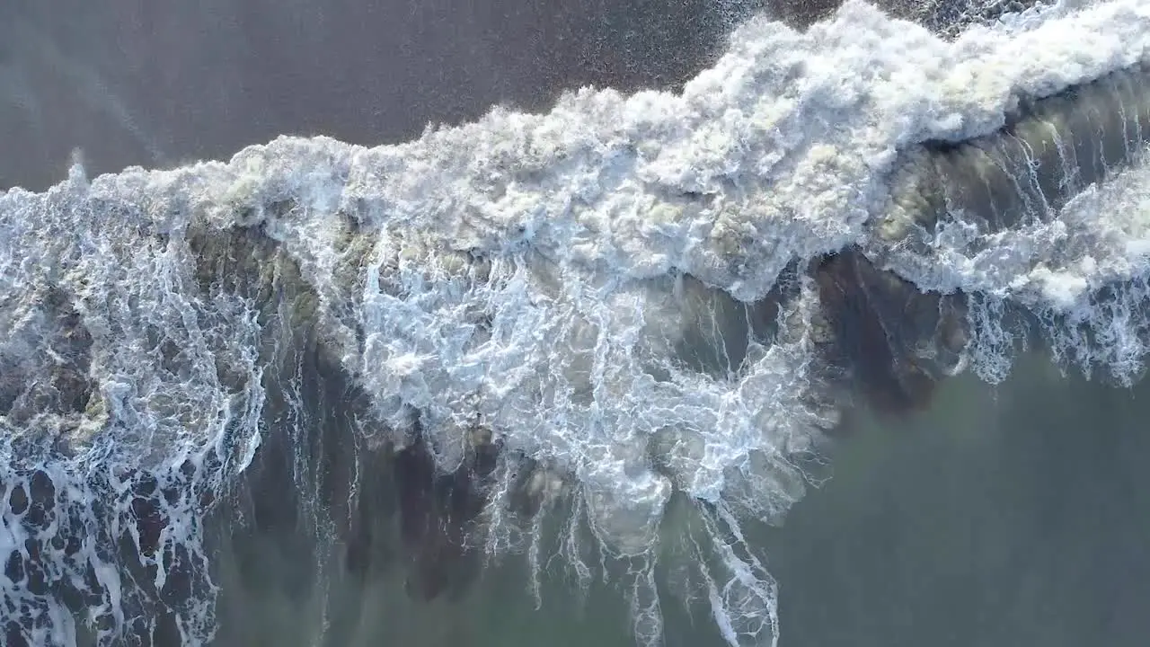 Cenital shot of the crushing waves by the beach in the morning in Carilo Argentina