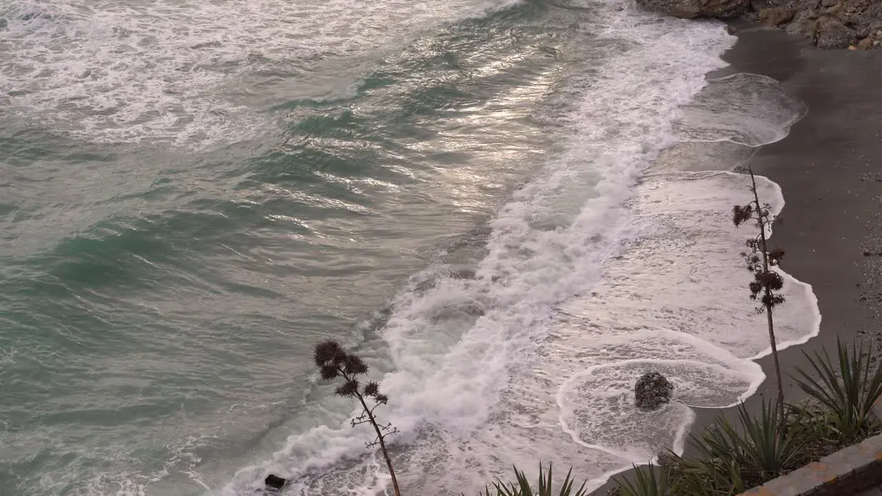 Looking down towards beach with big waves crashing