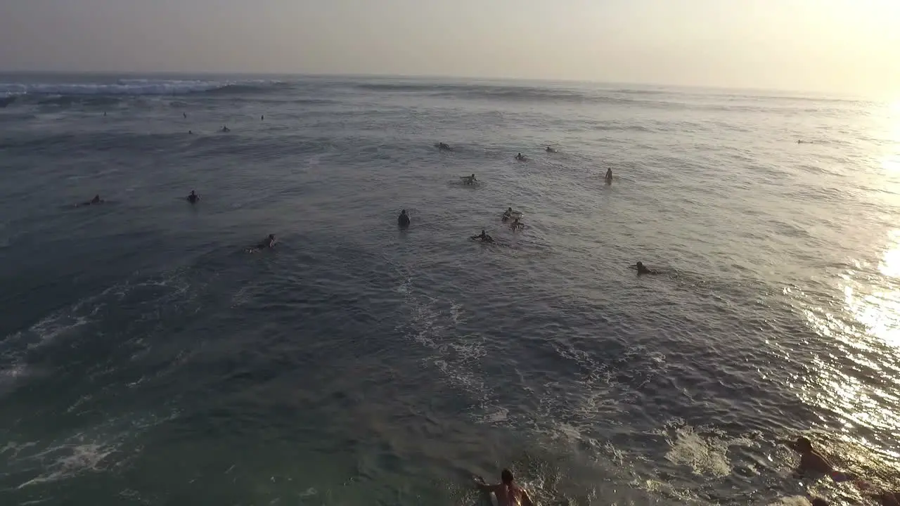 Aerial View Of Surfers On Surfboards In Rough Sea