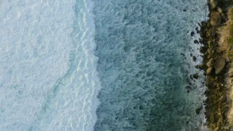 Drone Shot Looking Down at Waves at Uluwatu Coast