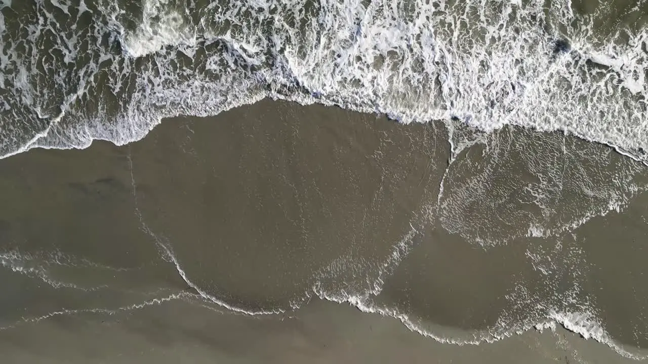 Crashing Waves as Camera Ascends Aerial Drone Oak Island NC