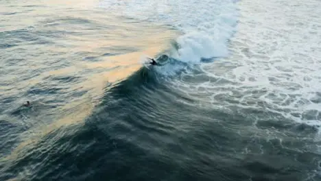 Drone Shot Following Surfer Riding a Wave