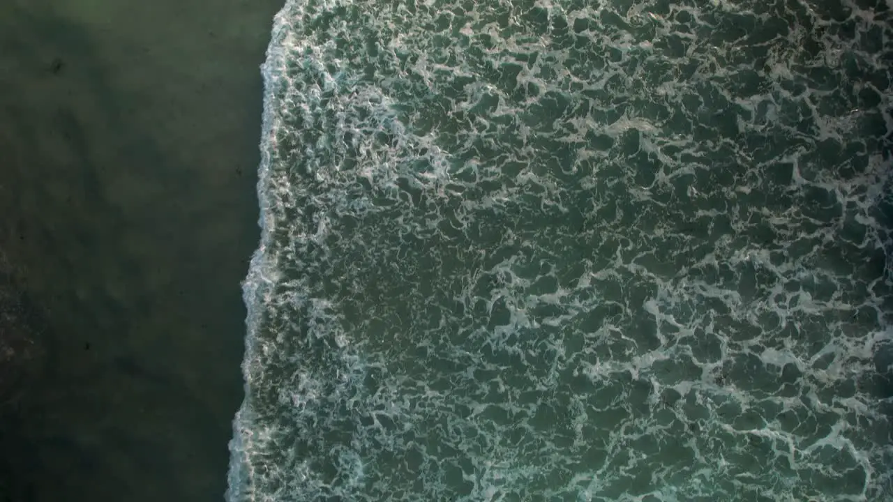 Ocean Splashing On The Shoreline With Foamy Waves