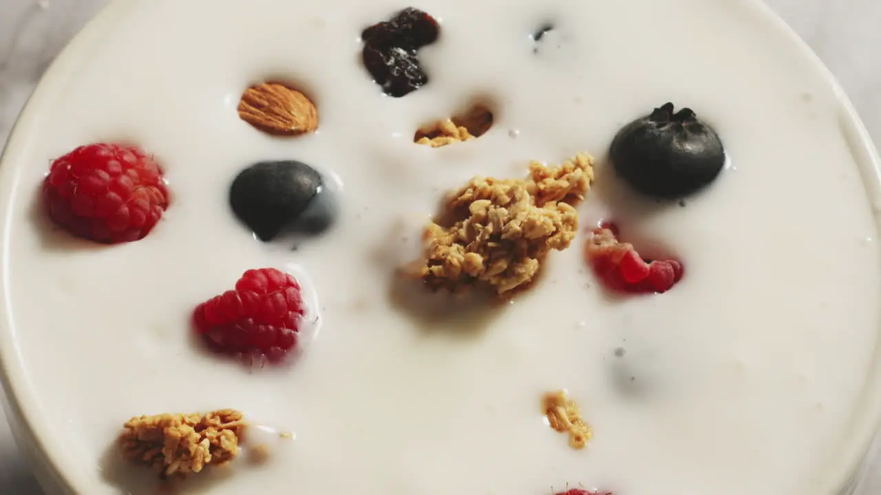 Vanilla yogurt with granola and blueberries whit spoon