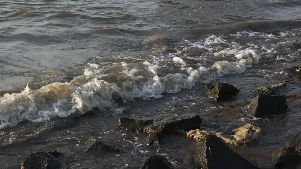 slow motion tidal sea waves and rocks on the beach