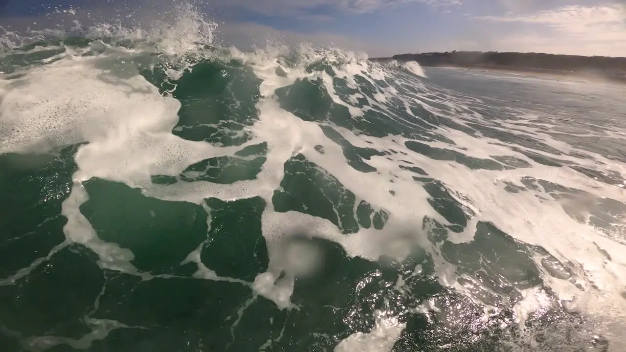 Surfer on Blue Ocean Wave attacking the lip with strong snaps