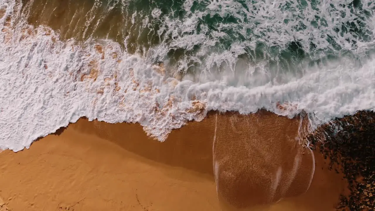 Overhead Shot Of Beautiful Wave Crashing On Magical Sandy Beach Ericeira Portugal