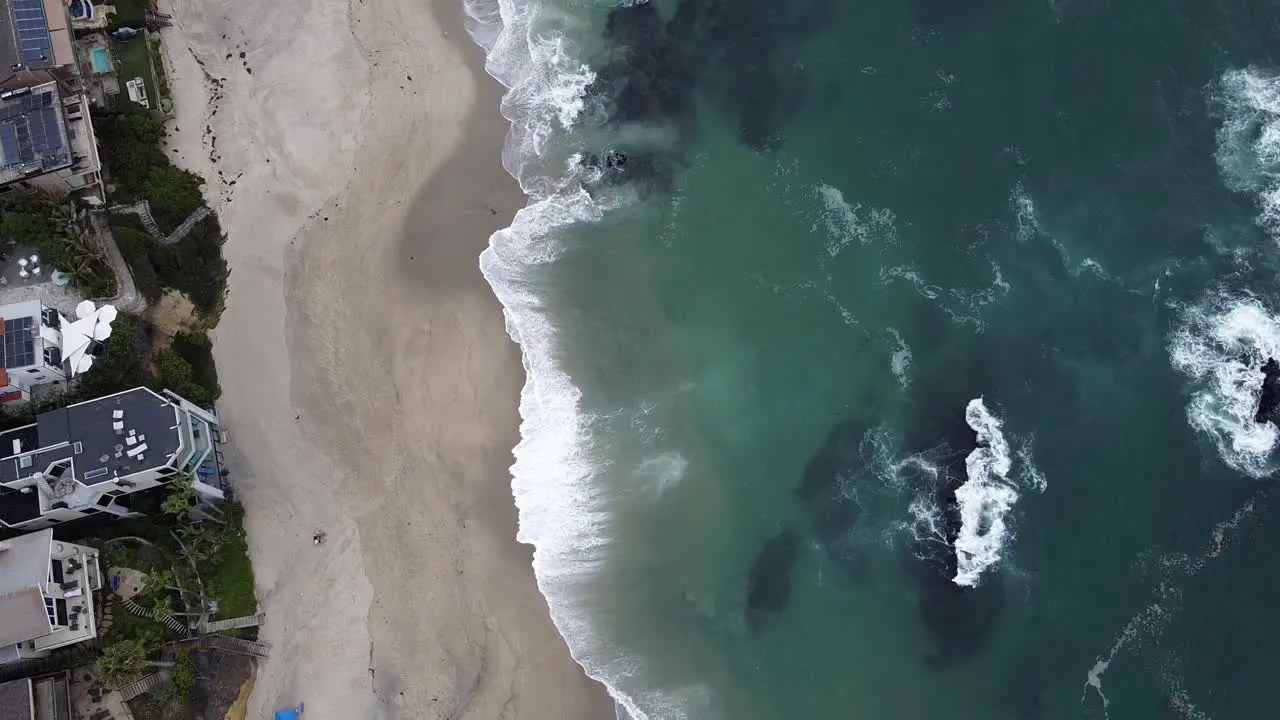 Calm Waves Crashing On Beach Shore by Luxury Homes Beach Town