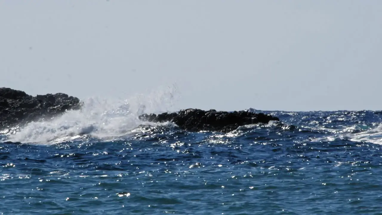 Scenic view of sea waves crashing onto rocks with water splashes Jerusalem Beach in Erisos Greece wide static