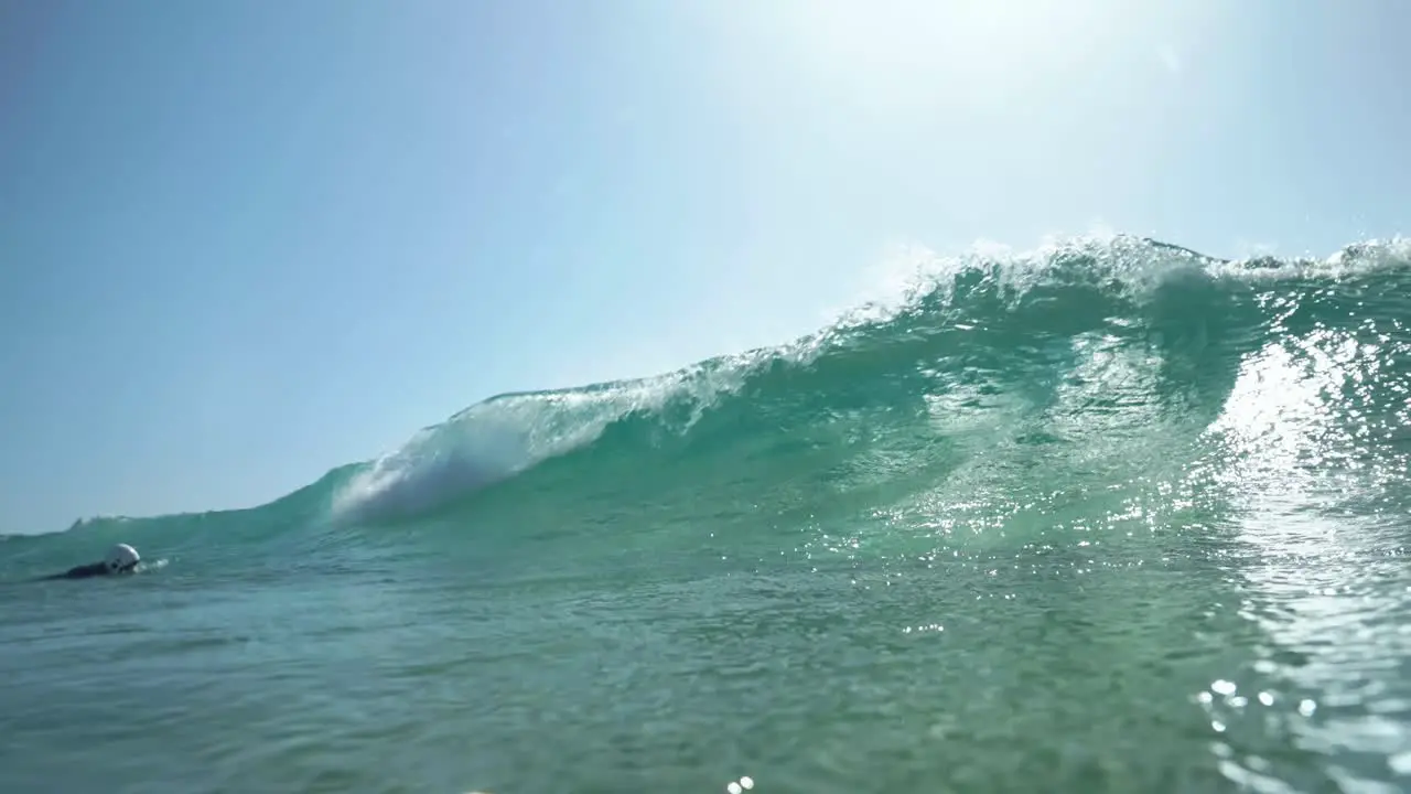 Floating surfer POV of a big wave in slow motion