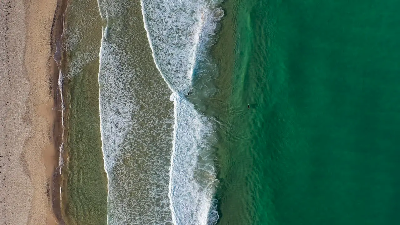 Drone shot of people surfing at Redhead beach