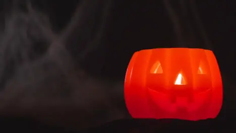 Halloween Pumpkin Jack-O-Lantern With Candle Against Black Background With Cobwebs 3