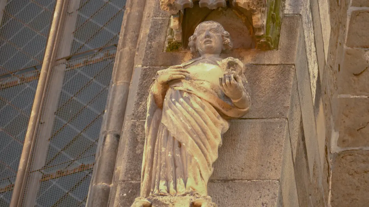 Stone statue of a female with a cup on the side of the gothic Black Church in Brasov Romania