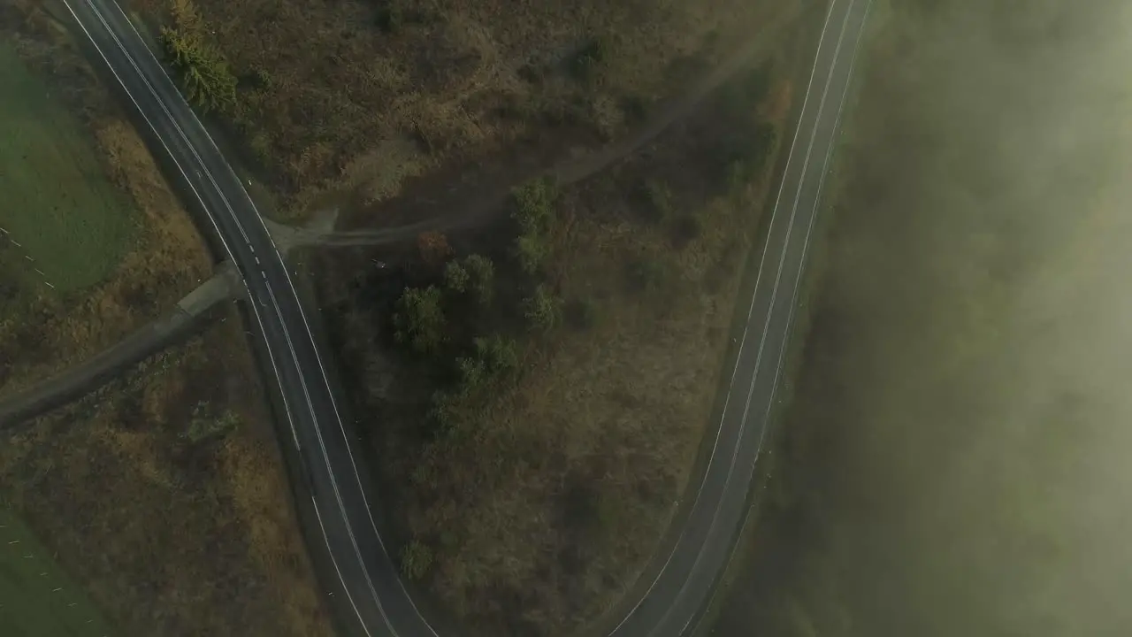 Misty landscape with curved road in rural area Poland aerial