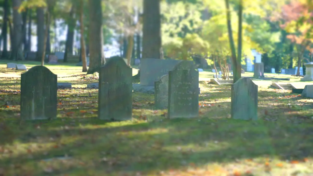 Sunlight and shadow pass over a group of gravestones in time-lapse