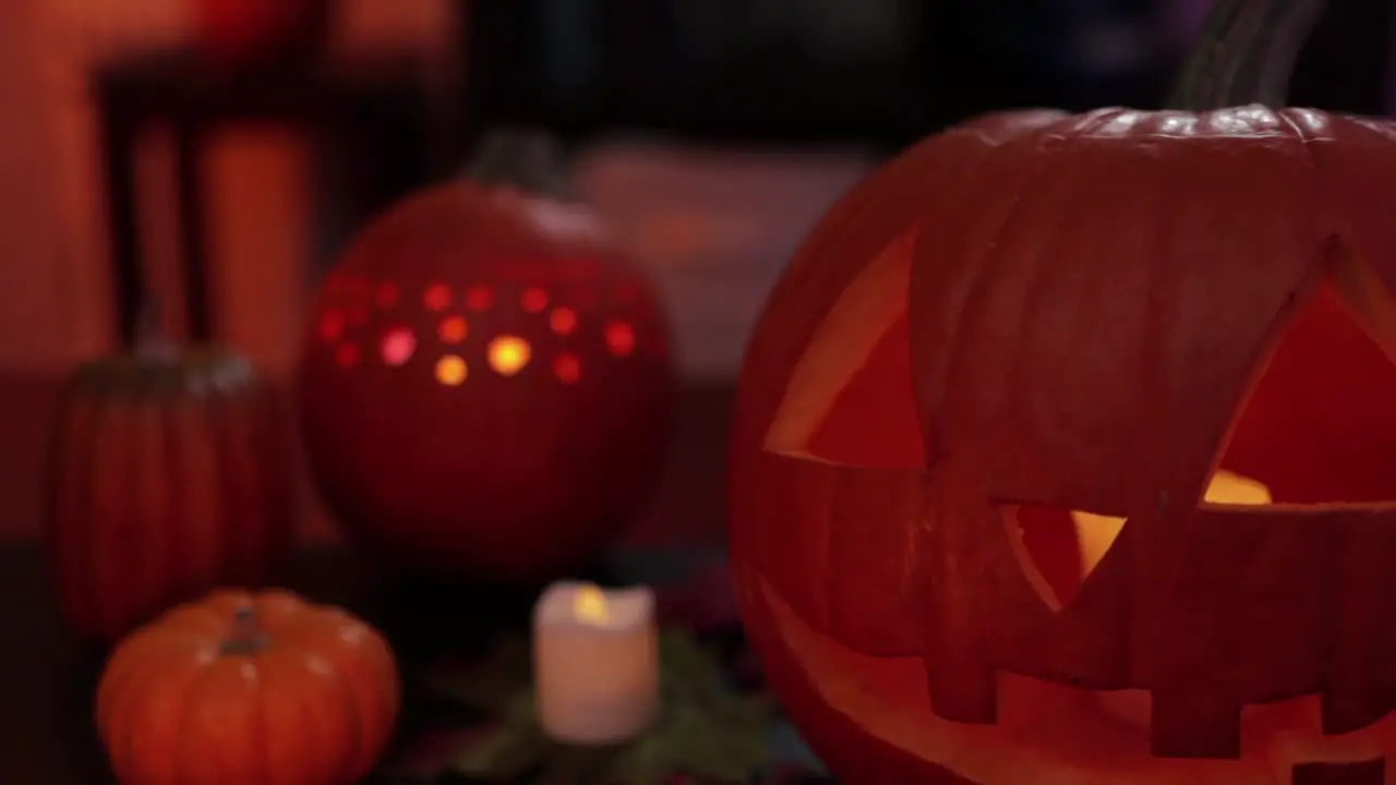 Spooky decoration for halloween with carved pumpkins and candles