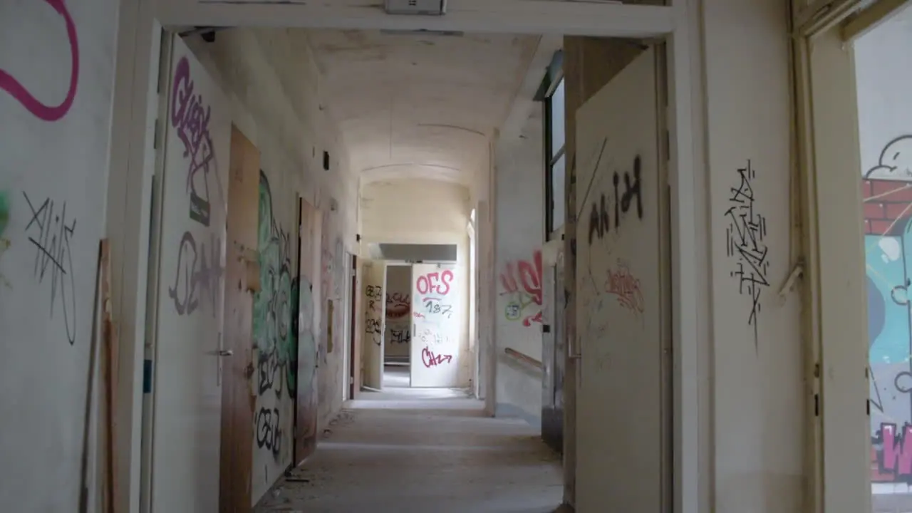 Long Corridor in a destroyed and abandoned Building with a lot of Graffiti