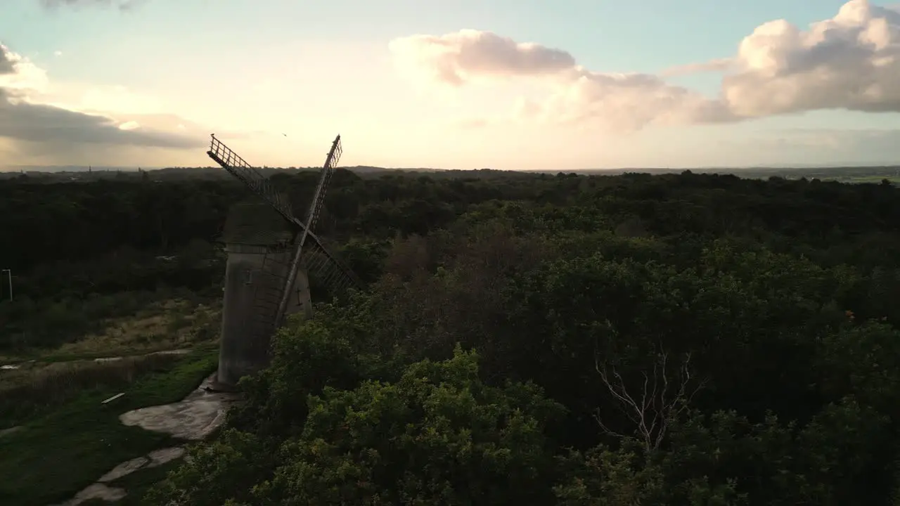 Bidston Windmill at dawn aerial drone clockwise storm cloud reveal