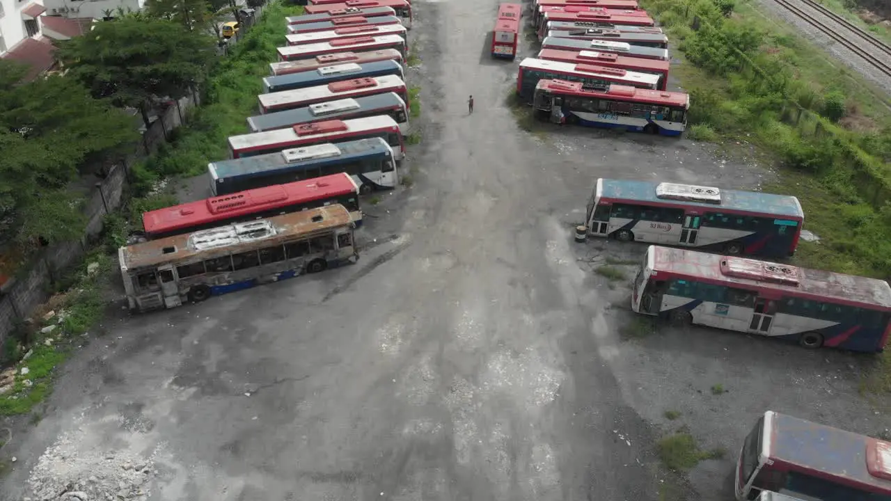 Reveal shot of busses junkyard at Kuala lumpur during a cloudy day aerial