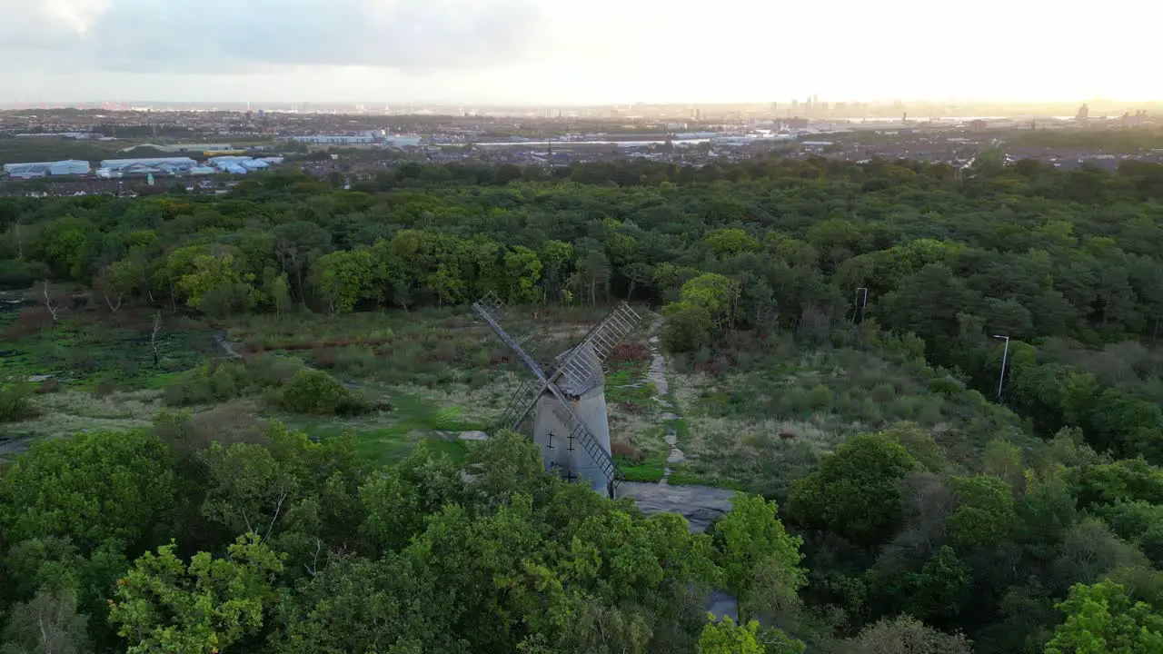 Bidston Windmill at dawn aerial drone clockwise inwards pan and Liverpool sunrise reveal