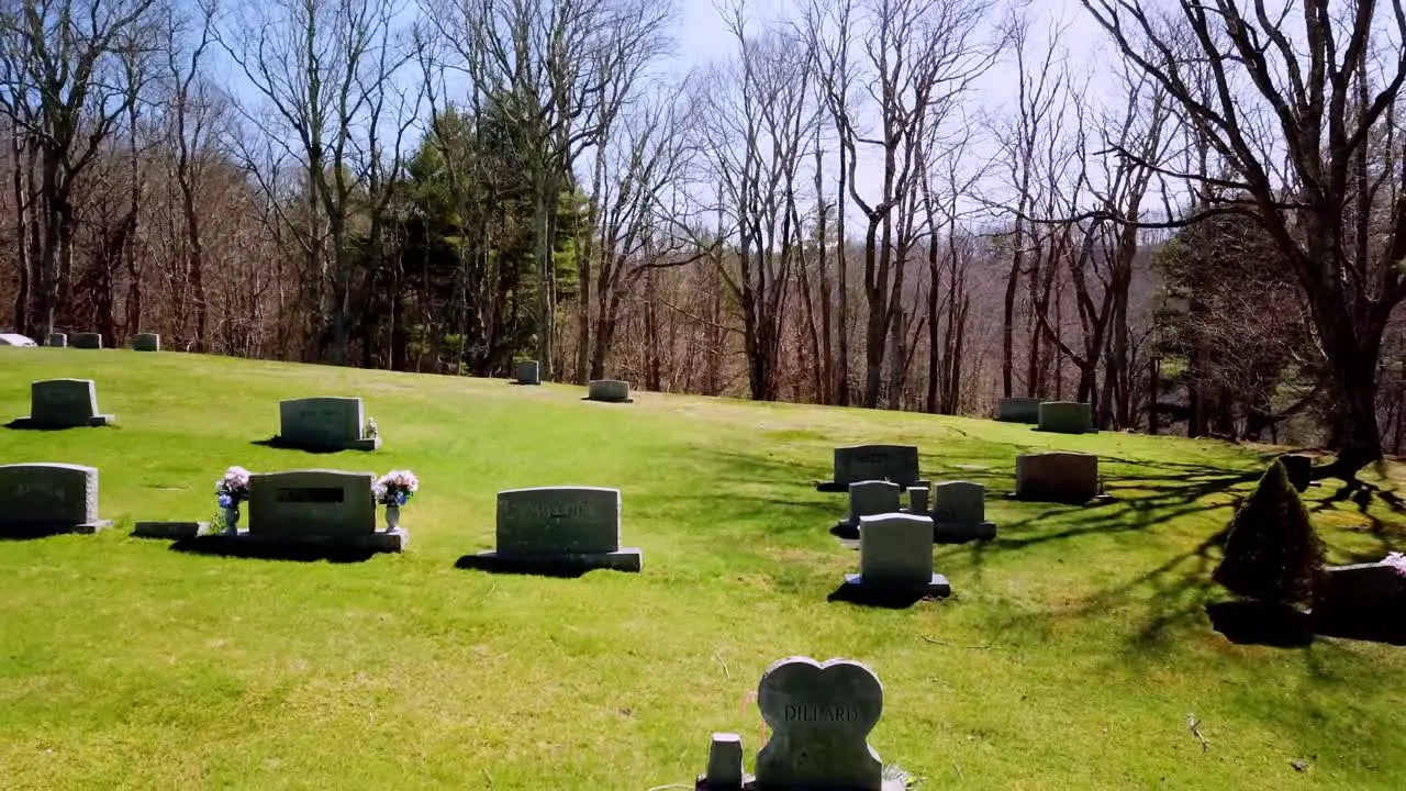 Aerial pullout through tree branches in graveyard in Mountains of North Carolina