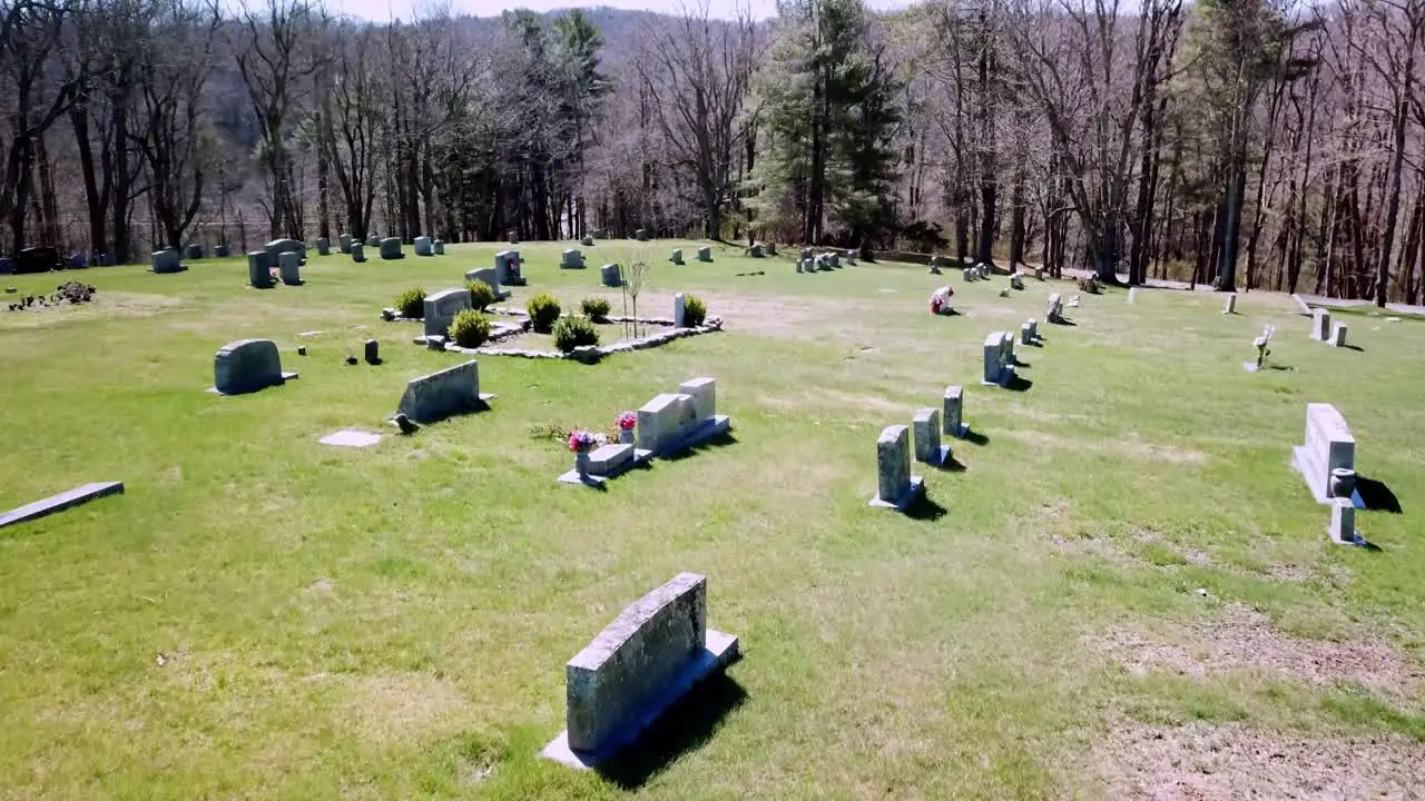 Smooth Aerial flyover of tombstone in graveyard