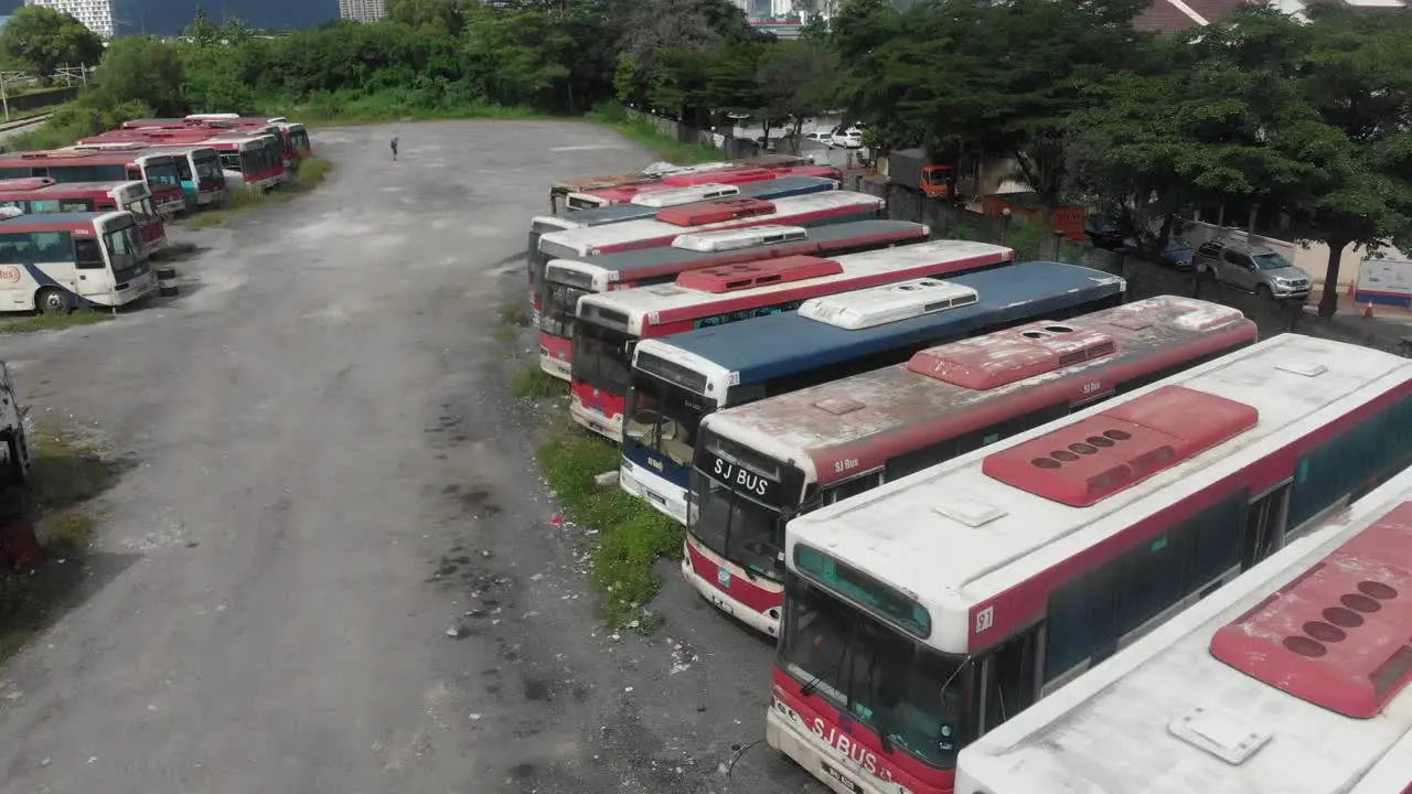 Old abandoned busses parked at junkyard at Malaysia aerial