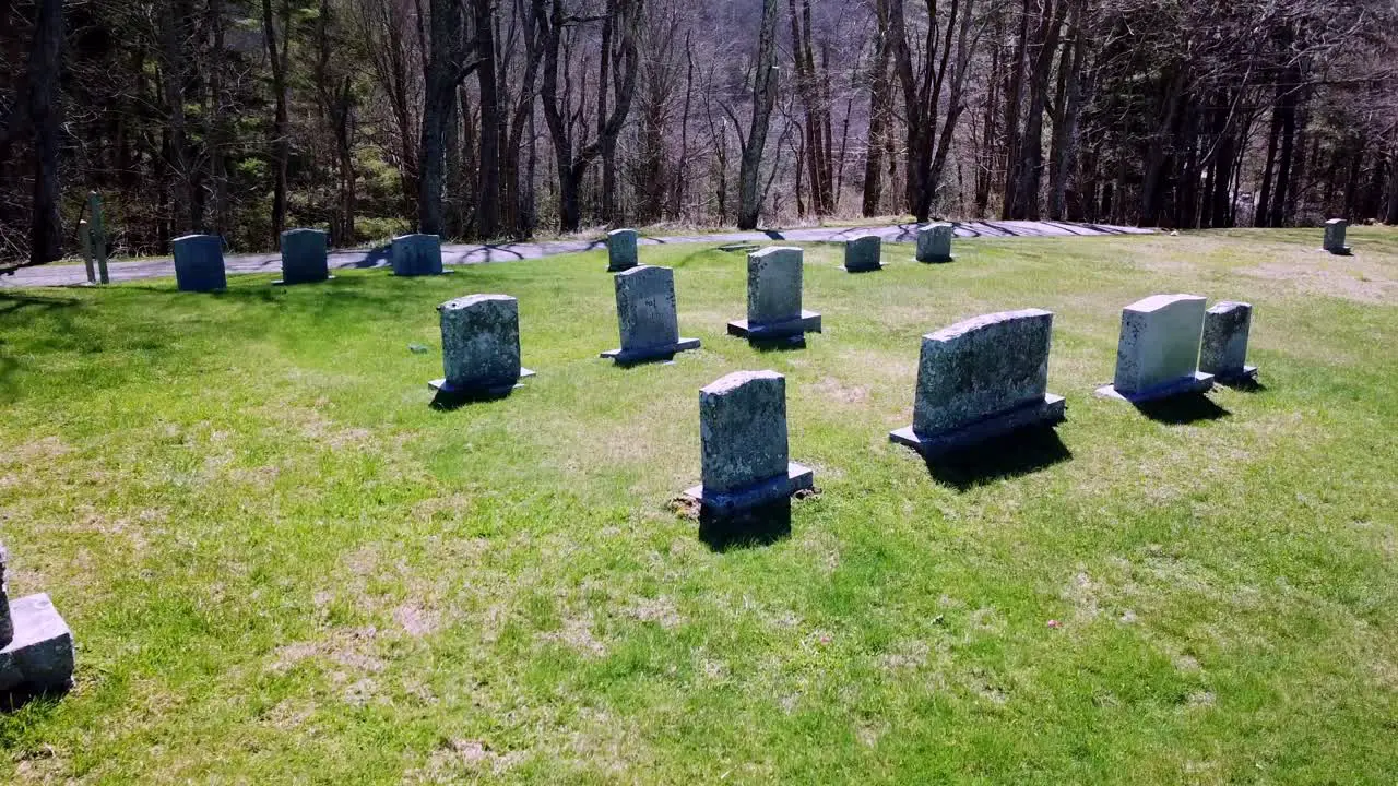 Aerial flyover of tombstones in graveyard