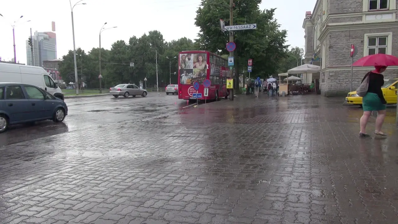 Tallinn Estonia pedestrians in the rain with umbrellas