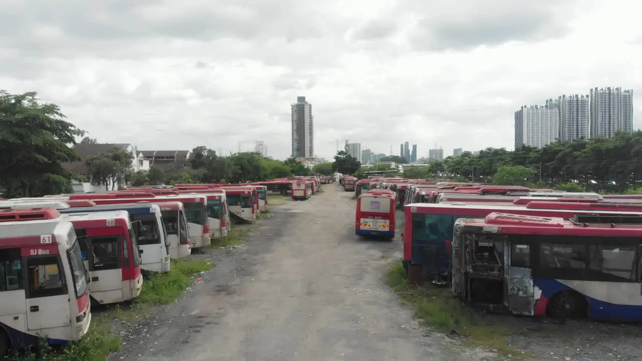 Low flying over old abandoned busses at junkyard at Kuala lumpur aerial