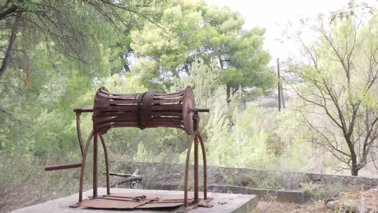 Pan handheld footage of old rusty abandoned well located at Kifissia Athens Greece