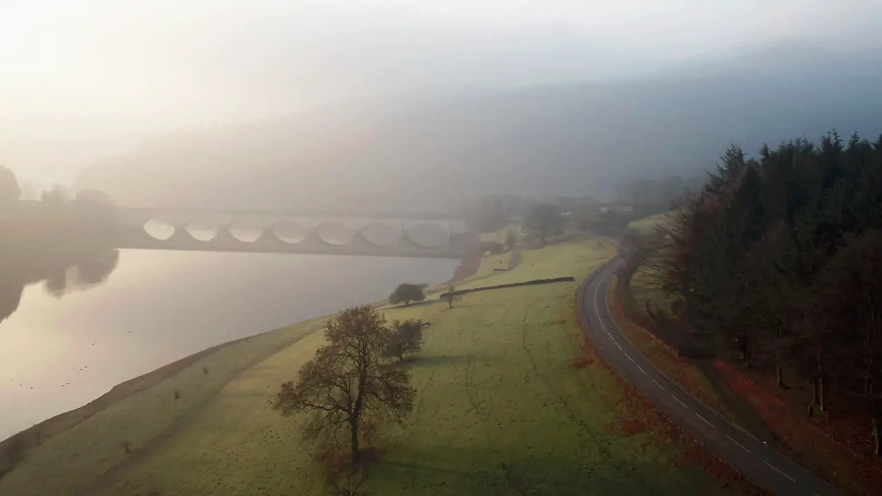 Sunrise on a misty morning over Ladybower reservoir in the Peak district UK