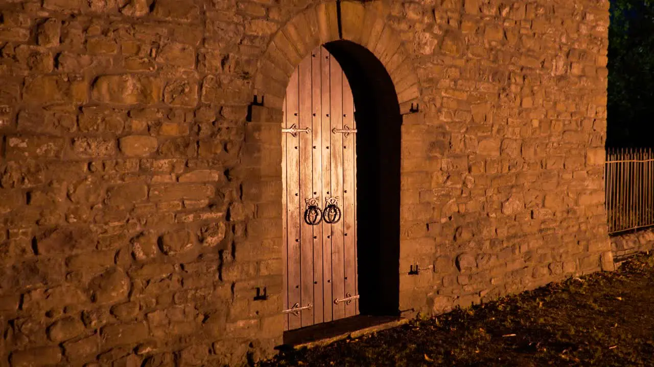 Old church lit up at night with railings