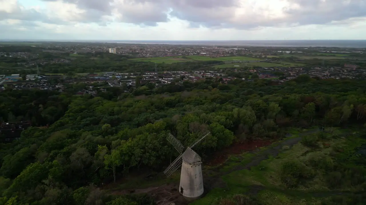 Bidston Windmill at dawn aerial drone anti-clockwise pan and inward sunrise reveal