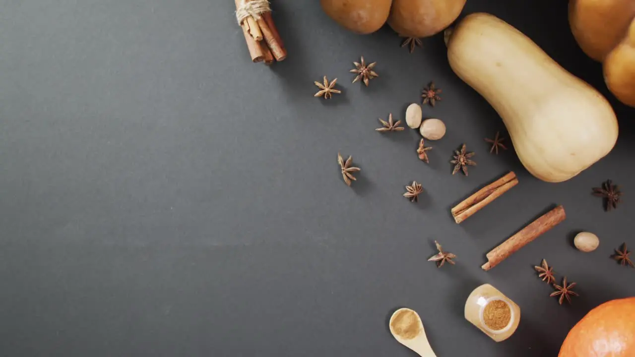 Video of pumpkins with autumn spices on black background