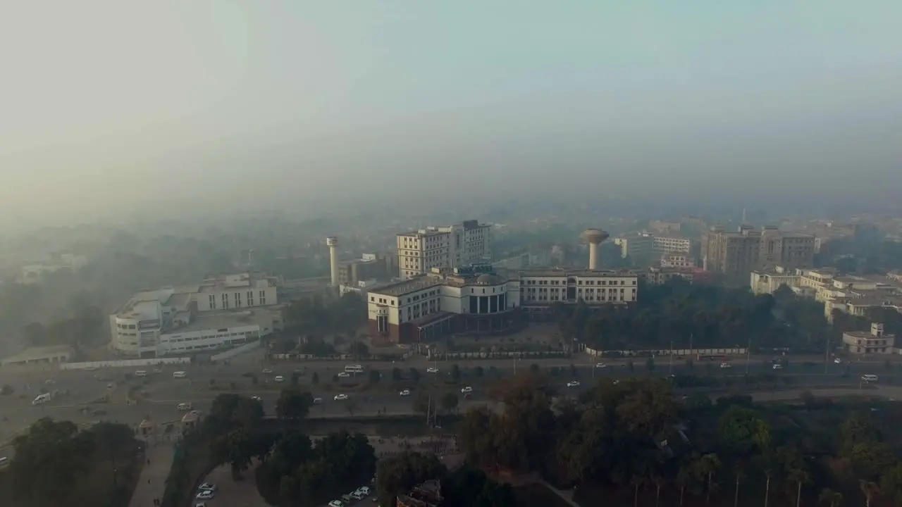 Bombay India Aerial flight over the horse riding ground and trraining areas starts from the central tower buildings foggy weather of the city traffic is going on the highway