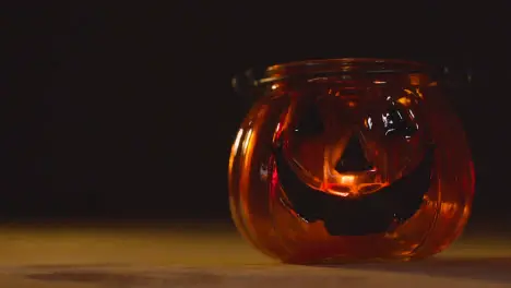 Halloween Pumpkin Jack-O-Lantern With Candle Against Black Background