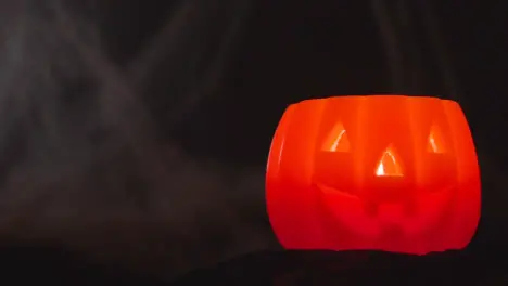 Halloween Pumpkin Jack-O-Lantern With Candle Against Black Background With Cobwebs 2