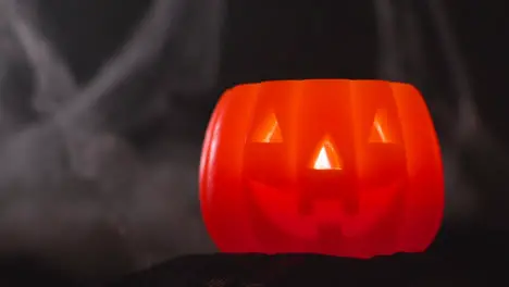 Halloween Pumpkin Jack-O-Lantern With Candle Against Black Background With Cobwebs 1