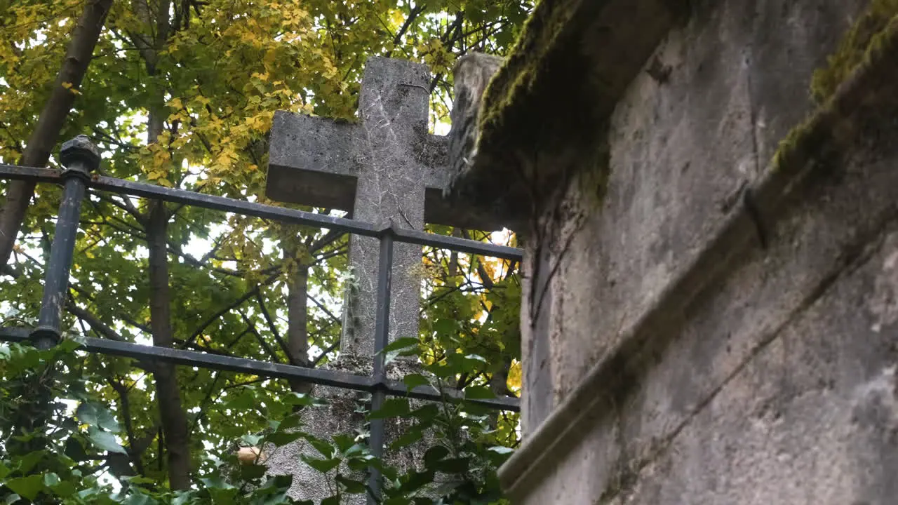 an old cross made of stone in the pere lachaise cemetary