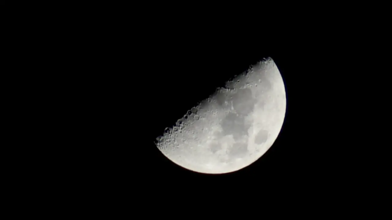 Half a moon zoomed in at night