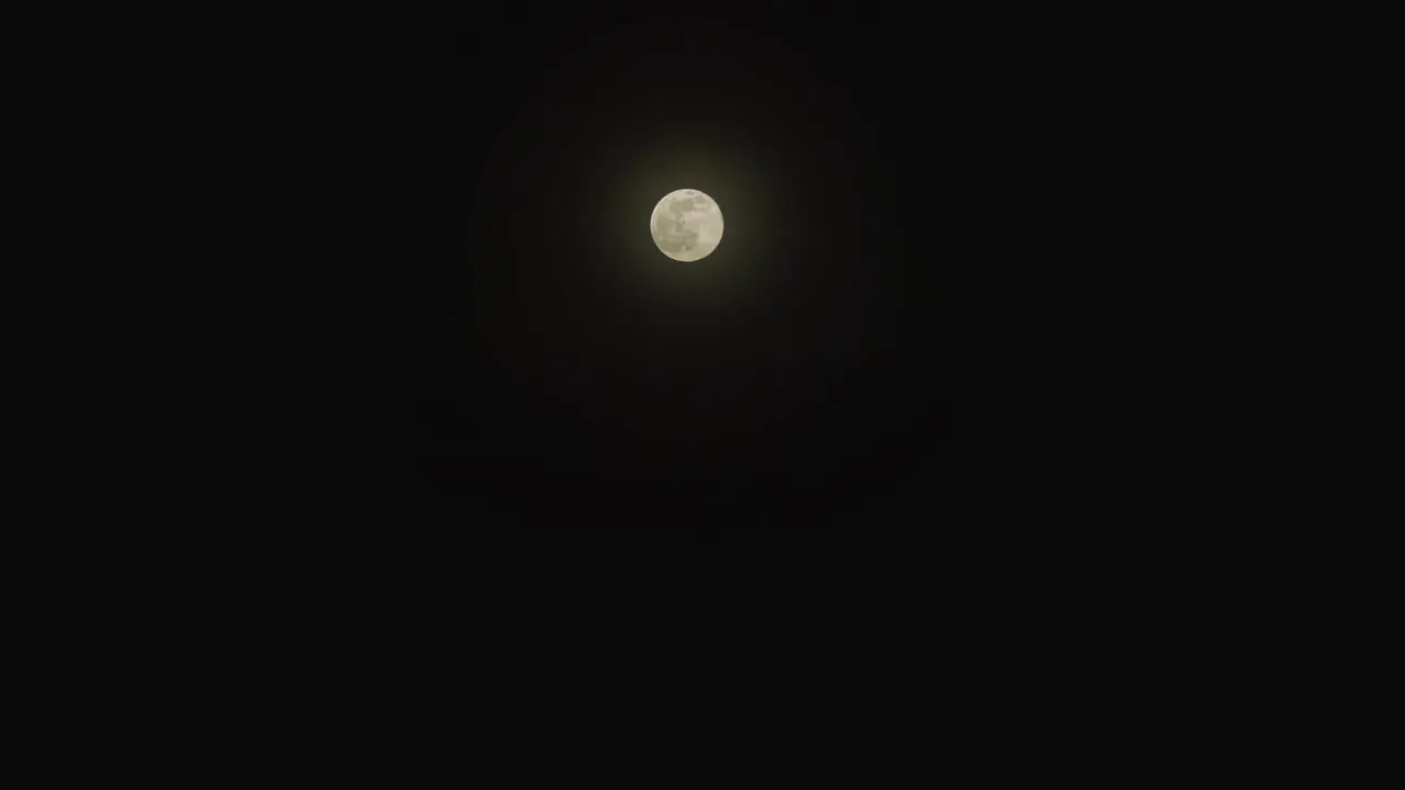 Small full moon on the dark sky